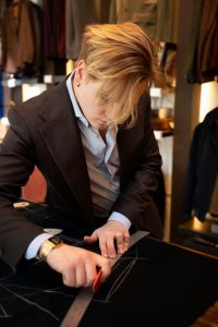 Tommy O’Shea chalking a hand-drafted pattern onto cloth